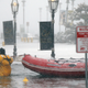 A boston firefighter wading through floodwaters in the aftermath of the ‘bomb cyclone’ on January 4, 2018